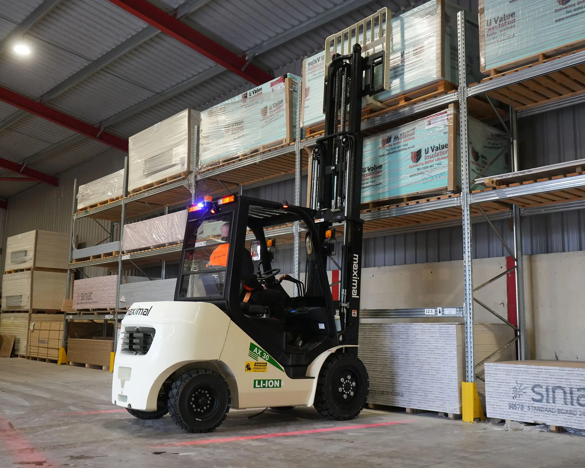 Forklift in Warehouse Lifting Cargo A forklift in a warehouse lifting cargo from a high shelf, showcasing industrial equipment and organized storage.
