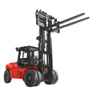A heavy-duty red forklift with extended forks, designed for lifting and transporting heavy loads in industrial settings.
